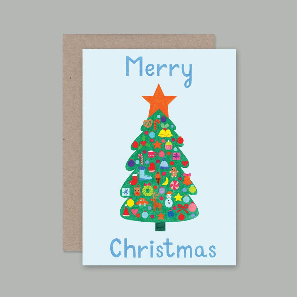 A Christmas greeting card with a kraft envelope, featuring a colourful illustrated Christmas tree with an orange star on a light blue background, with the words 'Merry Christmas' in blue text.