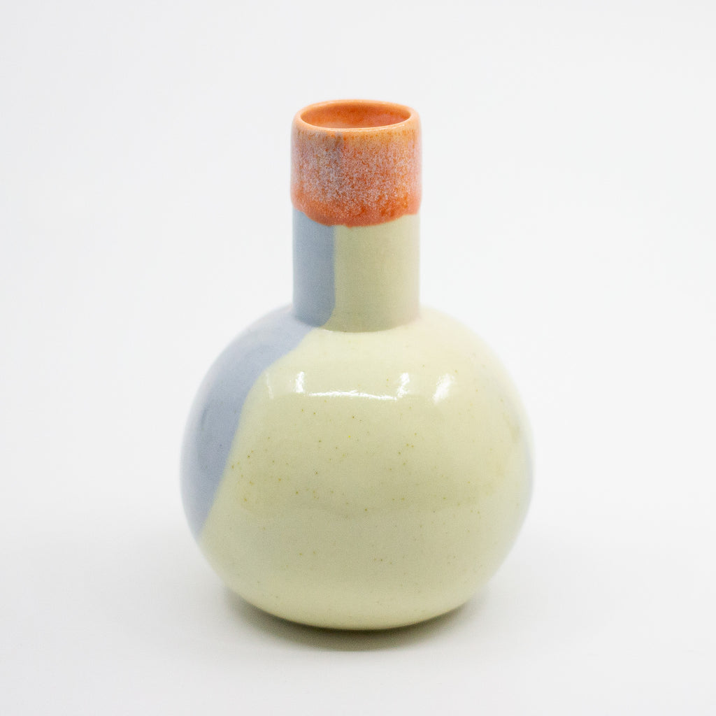 Ceramic vase with a light blue base and white top on a white background