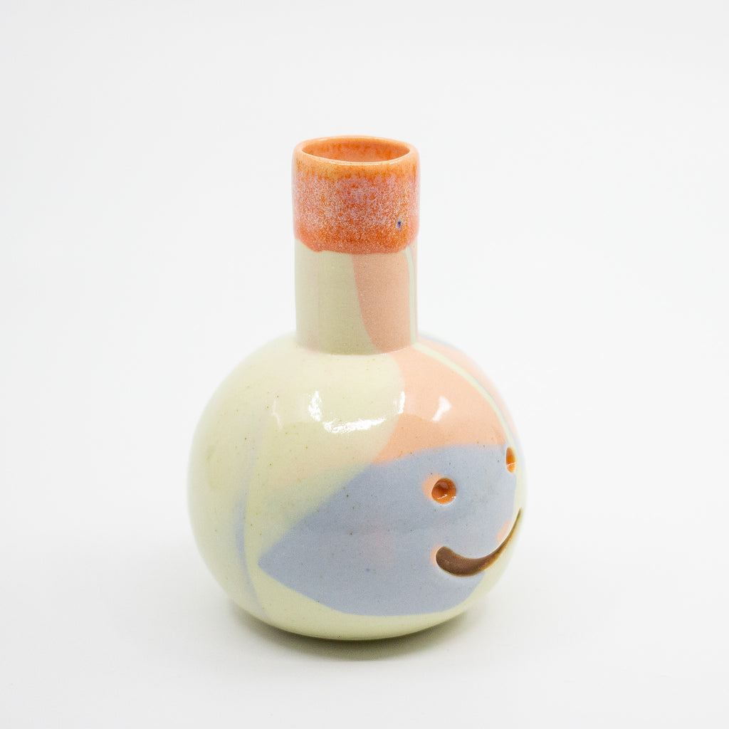Small ceramic vase with colorful design on a white background