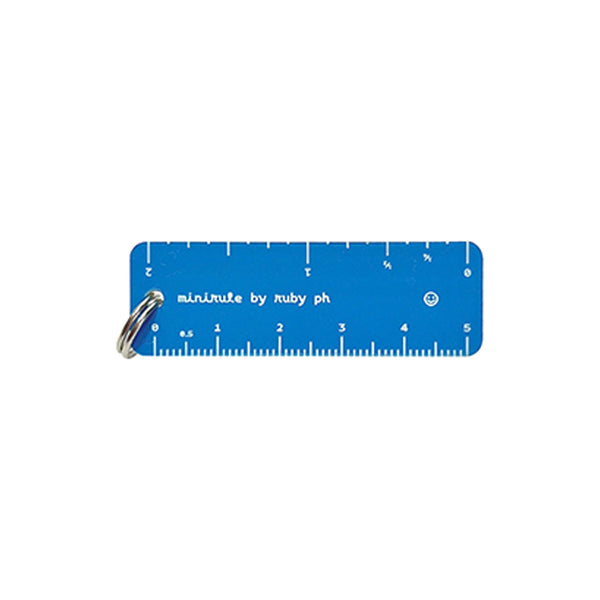 A blue pocket ruler keychain with white markings and a silver metal split ring, shown on a plain white background.