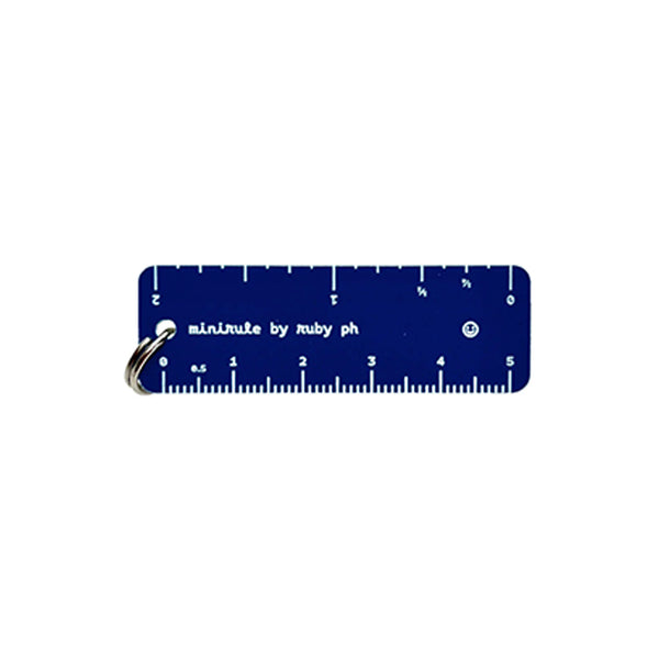 A navy blue keychain ruler with white markings and a silver metal keyring, branded 'minirule by ruby ph' on a plain white background.