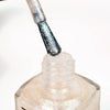 Close-up of a nail polish bottle with a brush