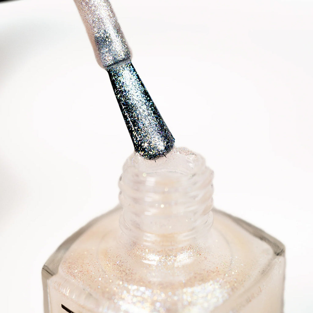 Close-up of a nail polish bottle with a brush