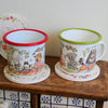 Two mugs with animal illustrations on a wooden surface.
