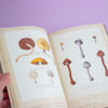 Open book with illustrations of mushrooms on a purple background