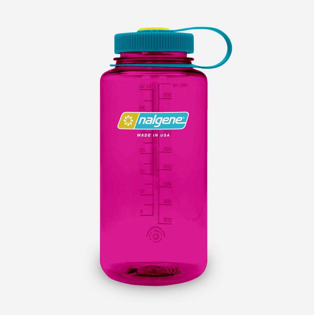 A translucent fuchsia pink Nalgene water bottle with a teal screw cap, teal carrying loop, and a yellow-and-teal logo on the front, shown on a light grey background.