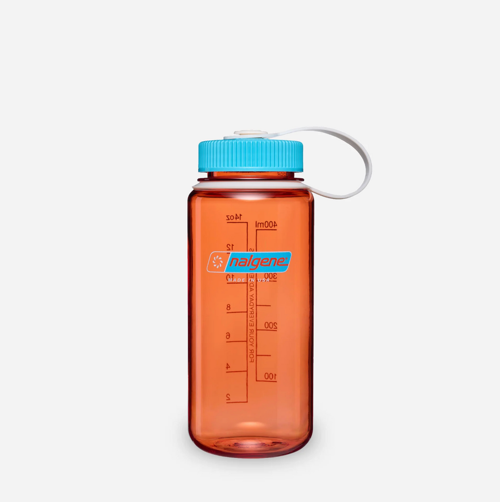 An amber translucent plastic water bottle with a bright blue cap and a white loop handle, featuring red measurement markings and a Nalgene logo on the front, set against a light grey background.