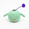 A front view of the Nishi Vase holding a flower. Green with purple flower. 