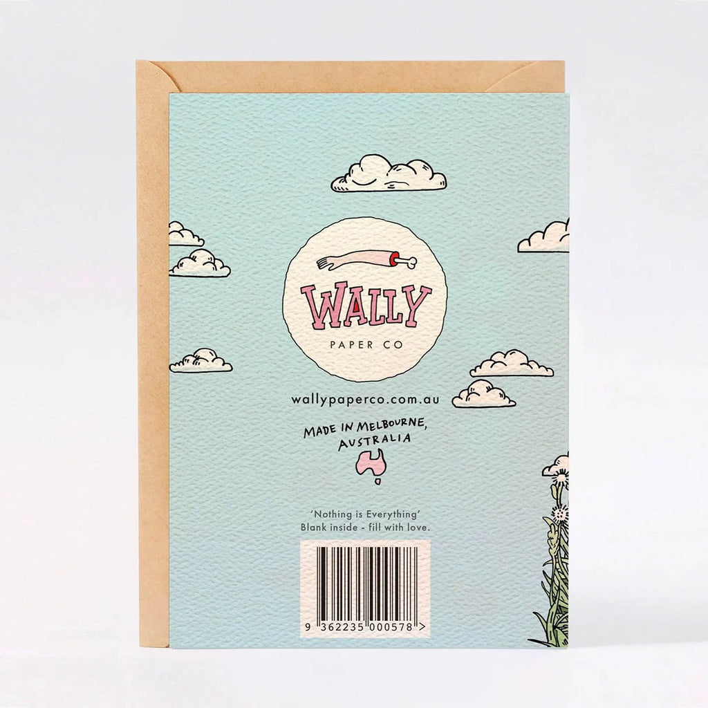 The back of a Wally Paper Co greeting card in a light blue textured paper, featuring a kraft envelope, with illustrated clouds, shape of Australia, and a barcode.