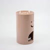 Pink ceramic oil burner with smiley face design on a white background