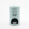 Light Blue Ceramic oil burner with smiley face design on a white background