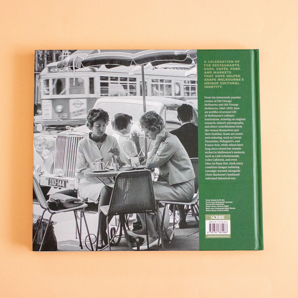 The back cover of a book, shown flat against a solid peach background. The cover features a black and white photograph of women sitting at an outdoor cafe table with a vintage bus in the background, next to a solid green spine band containing white text.
