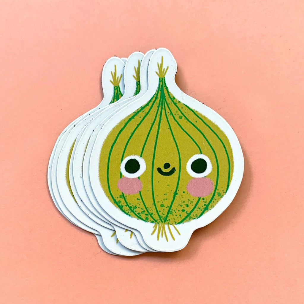 Stack of cute cartoon onion magnets on a peach background