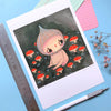 Illustration of a cute character surrounded by mushrooms on a piece of paper with a pen and ruler on a blue background.