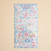 A pastel pink and blue sticker sheet featuring cute cartoon characters, bows, flowers, and decorative elements, displayed against a solid beige background.