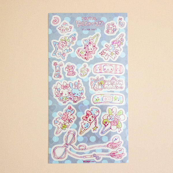 A pastel pink and blue sticker sheet featuring cute cartoon characters, bows, flowers, and decorative elements, displayed against a solid beige background.