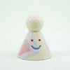 Small ceramic figurine with a smiley face on a white background