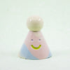 Colorful ceramic figure with a smiley face on a white background