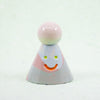 Small ceramic figure with a smiling face on a white background