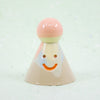 Ceramic figurine with a smiling face on a white background