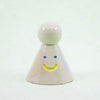 Small ceramic figure with a smiley face on a white background
