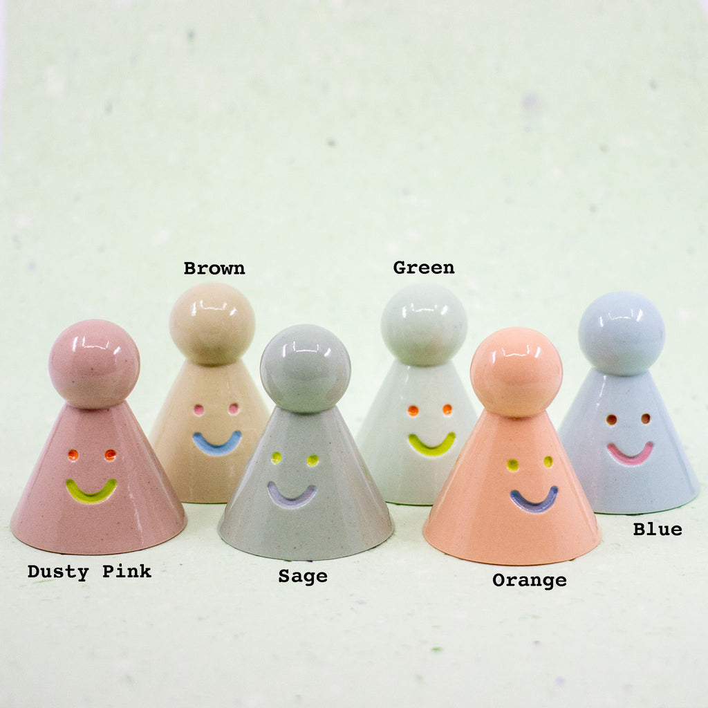 Set of colorful character-shaped objects with labeled colors on a light background