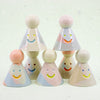 Set of colorful ceramic cone-shaped toys with smiling faces on a white background