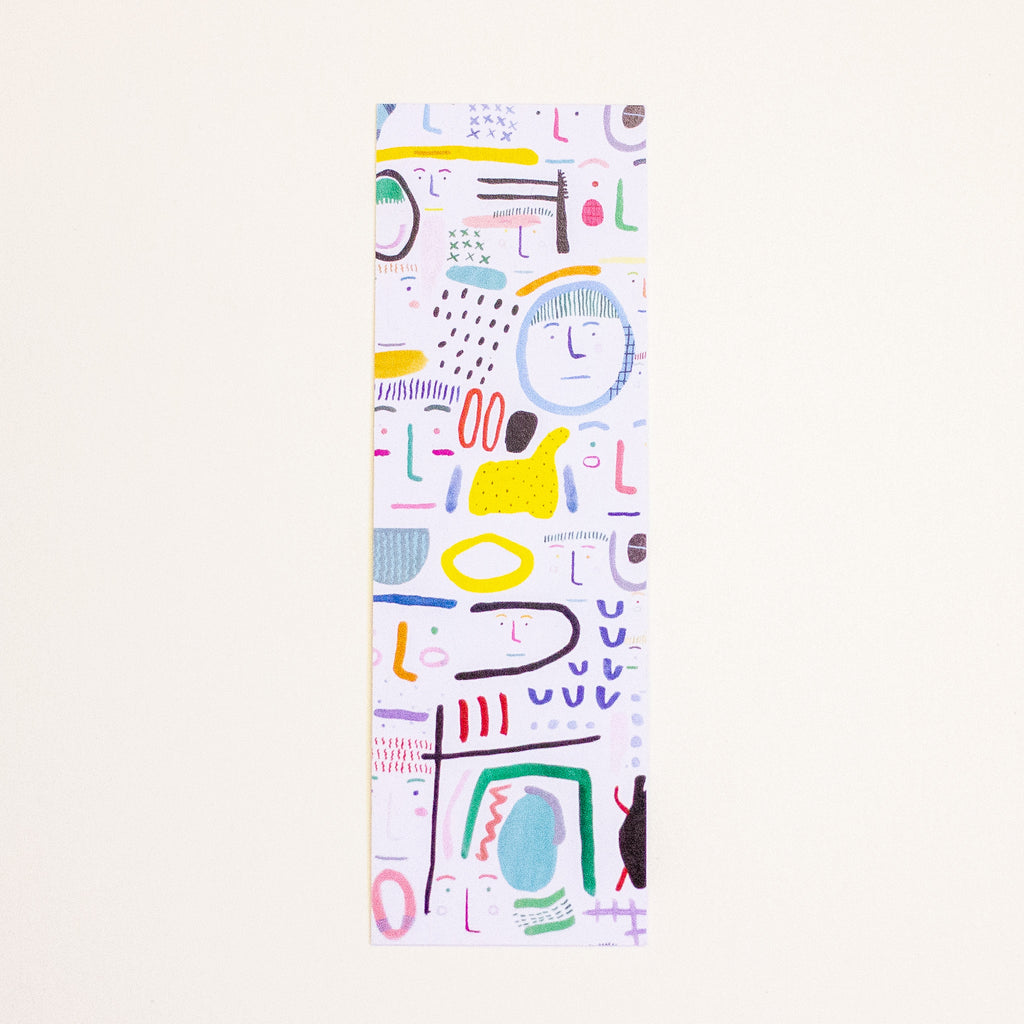 A tall, narrow rectangular bookmark featuring a colourful abstract pattern on a white background, displayed against a solid off-white backdrop.