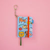 Small notebook with colourful animal illustrations on a pink background