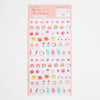 A sheet of cute daily seal stickers with various food and character illustrations on a white background, featuring a pink header card.