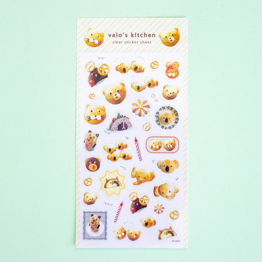 A clear sticker sheet from 'valo's kitchen' featuring cute cartoon koala bear illustrations in various poses, displayed on a light mint green background.