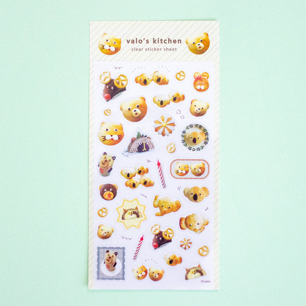 A clear sticker sheet from 'valo's kitchen' featuring cute cartoon koala bear illustrations in various poses, displayed on a light mint green background.