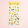 A sheet of cute animal-themed stickers from 'valo's kitchen' featuring teddy bears, bunnies, and dogs in yellow, brown, and green, displayed on a soft pink background.