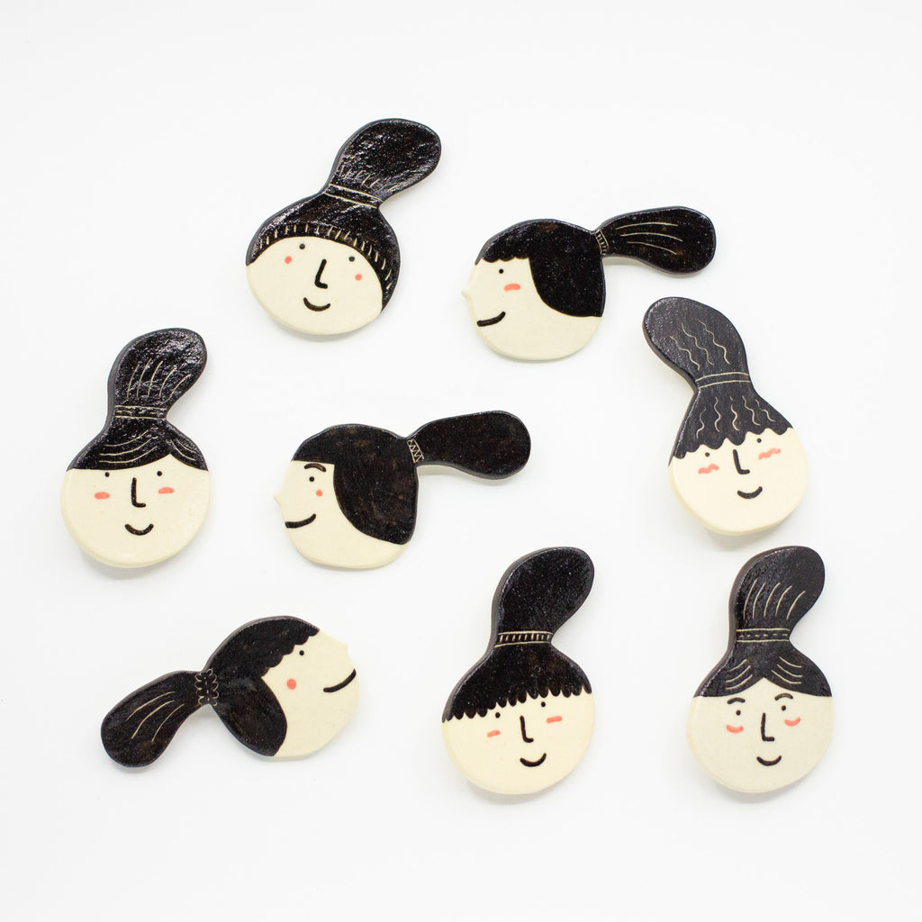 A Top View of the Ponytail collection of ceramic brooches. 