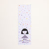 A tall, narrow bookmark featuring a white grid background with scattered multicoloured confetti dots and a simple black line drawing of a person near the bottom. Text on the card reads 'shuh.', 'printed in australia', and 'shuhlee.com'.