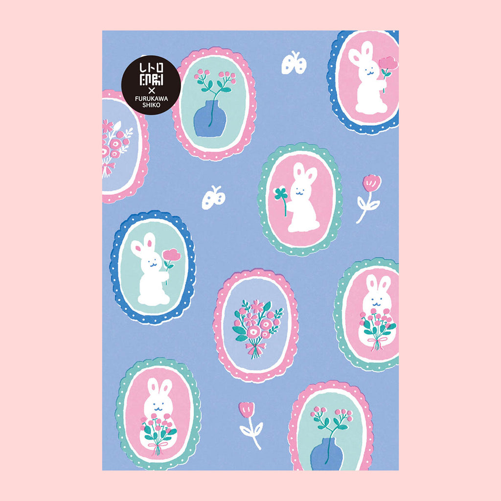 A postcard featuring a pastel bunny pattern on a light blue background, with multiple oval frames containing white rabbits, flowers, and butterflies. 