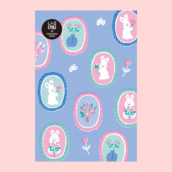 A postcard featuring a pastel bunny pattern on a light blue background, with multiple oval frames containing white rabbits, flowers, and butterflies. 