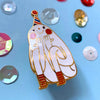 Decorative pin of a cartoon in a party hat on a blue background with colouful sequins.