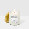 Candle in a glass jar with a visible label on a white background
