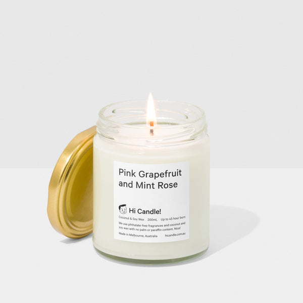 Candle in a glass jar with a visible label on a white background
