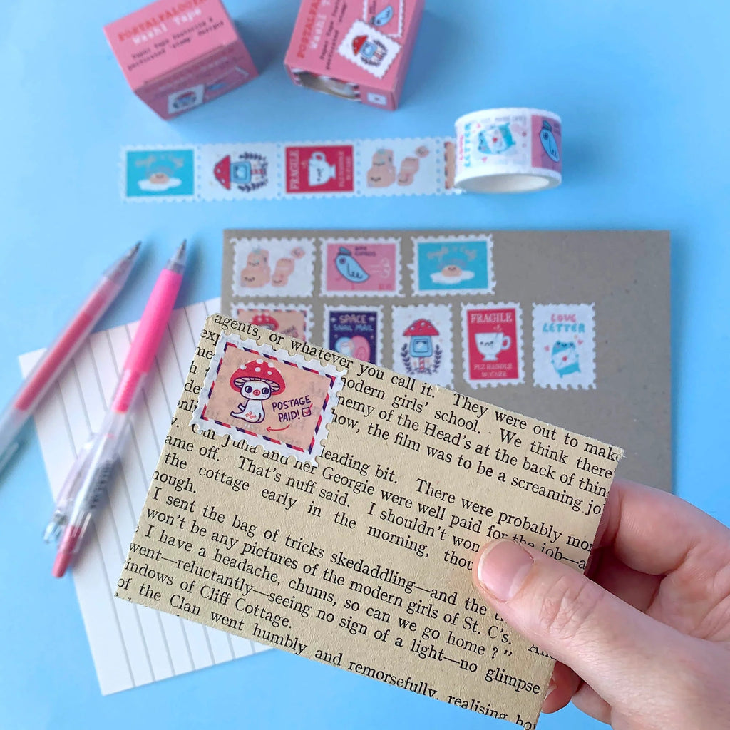Card with decorative stamps and stationery items on a blue background
