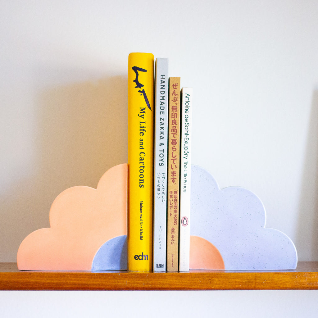Two quarter flower bookends holding up books. 