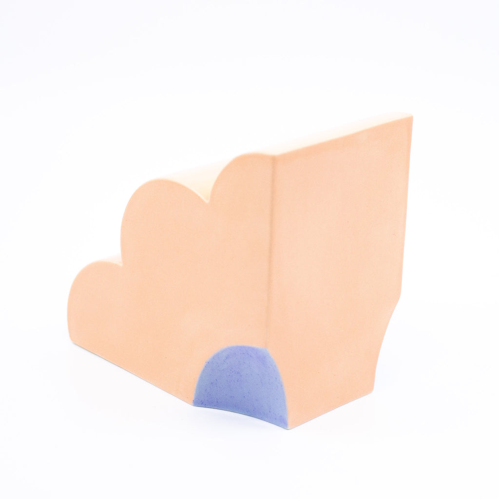 Side view of the peach coloured bookend, with blue highlight. 
