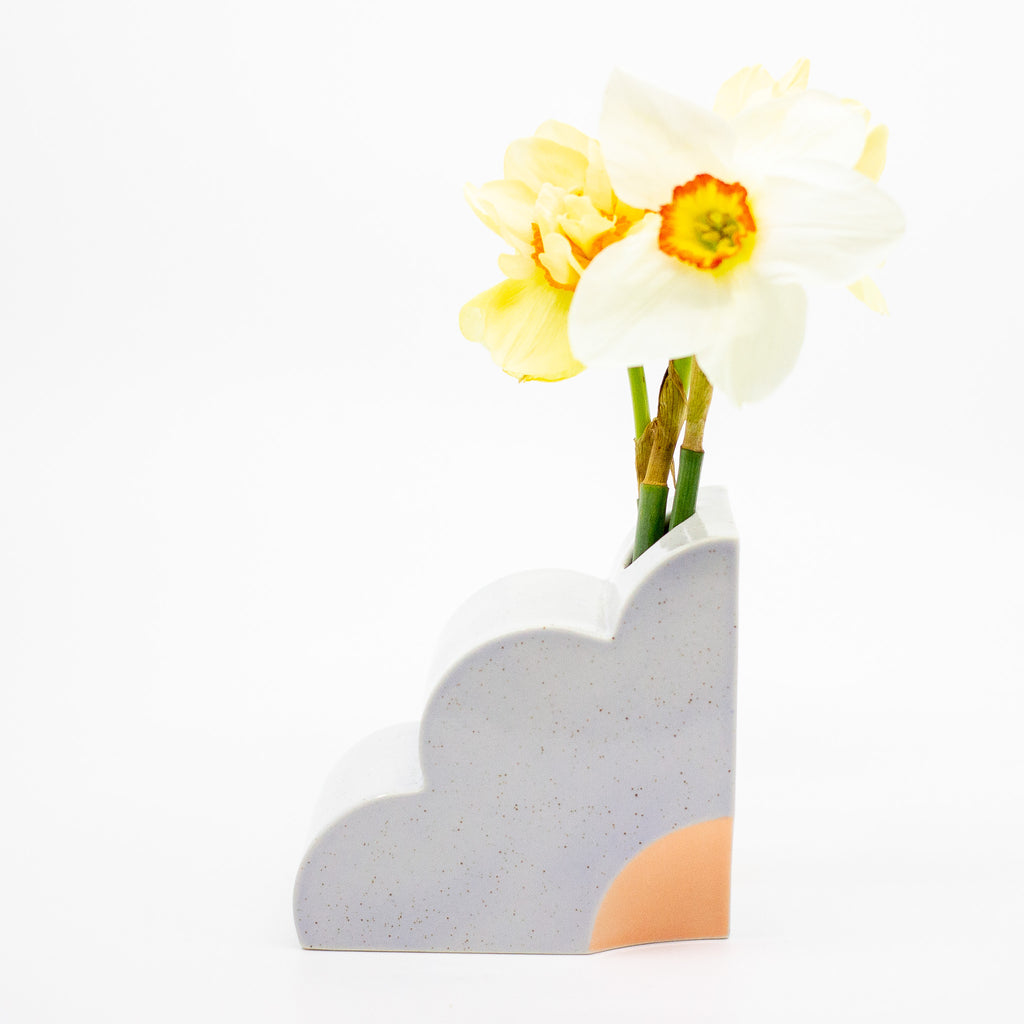 Lilac abstract vase with yellow flowers on a white background