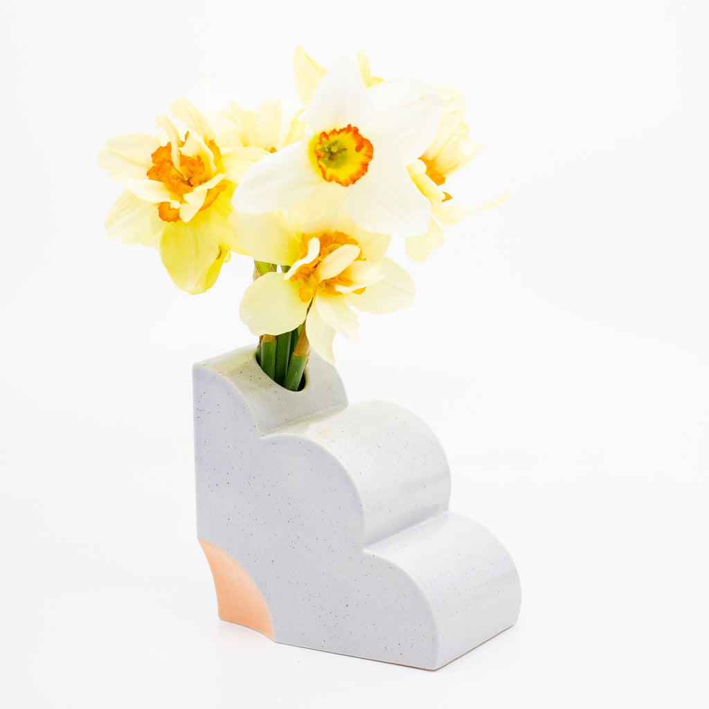 Lilac abstract vase with yellow flowers on a white background