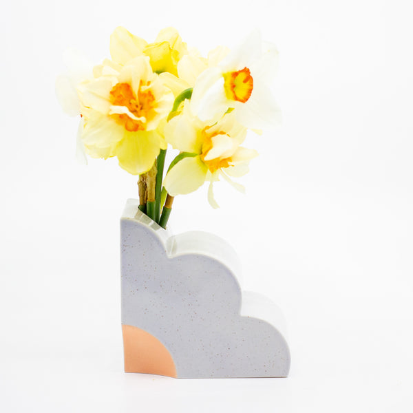 Lilac abstract vase with yellow flowers on a white background