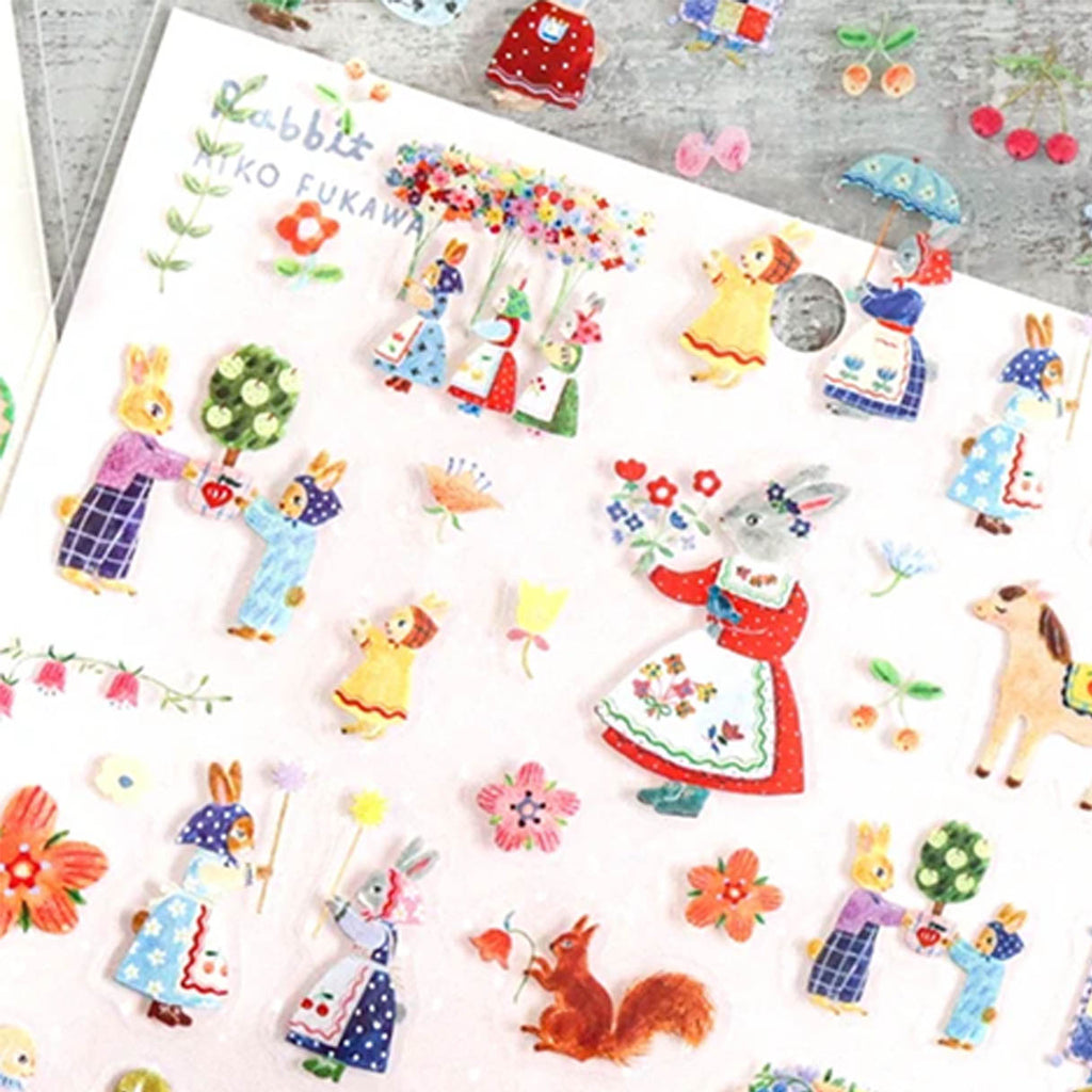 A sticker sheet of rabbit-themed illustrations, featuring colourful rabbits, flowers, and whimsical characters on a white backing card.