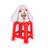 A die-cut sticker featuring a cartoon illustration of a white rabbit sitting on a red stool and holding a wine glass, set against a plain white background.