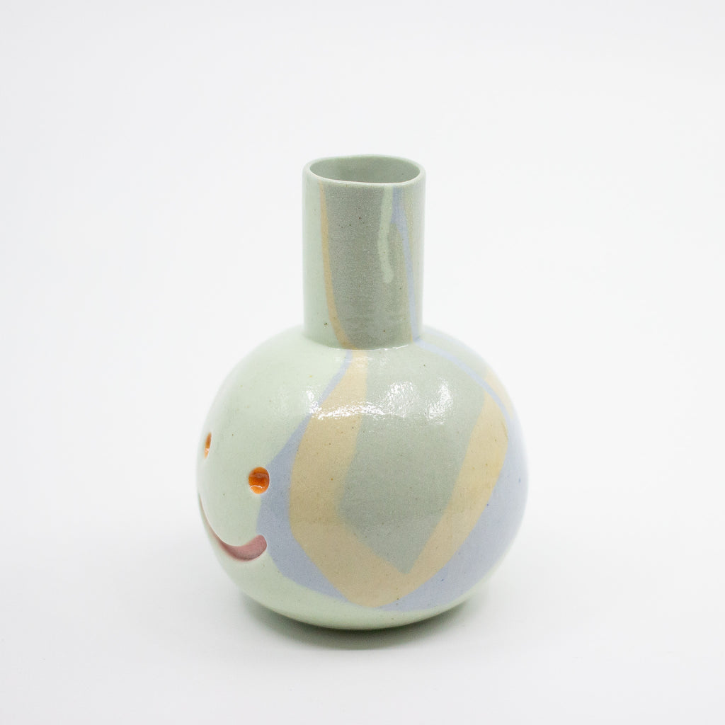 Ceramic vase with abstract design on a white background