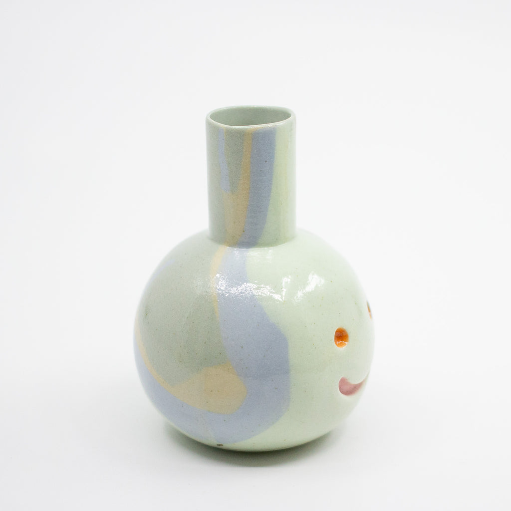 Round ceramic vase with colorful abstract design on a white background